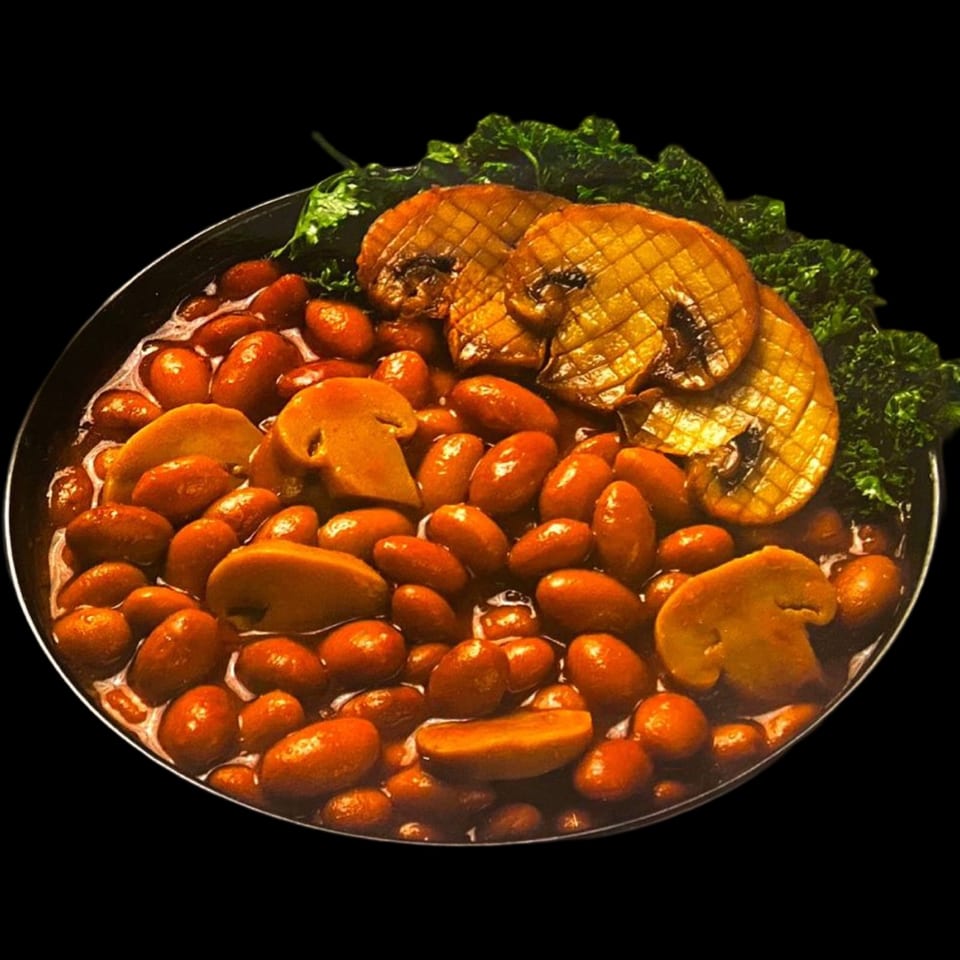 A bowl of Nora's Grill & Bistro's Mediterranean baked beans with mushrooms and parsley.